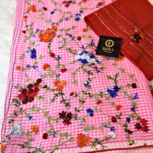 Baby Pink Kota saree with multicolor floral embroidery and delicate vine patterns across the fabric, showcasing detailed handcrafted thread work.