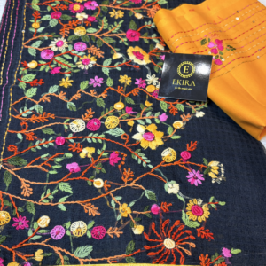 Black Kota cotton saree with vibrant multicolor floral vine embroidery, paired with a mustard blouse and finished with an elegant zari border, showcasing intricate handcrafted thread work.