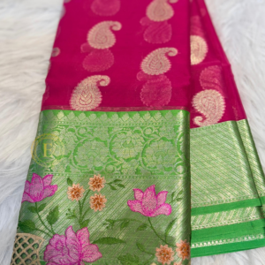 Rani pink semi Banarasi georgette saree with golden paisley buttas and a green Kanchi-style border featuring gold zari and floral embroidery by Ekira.