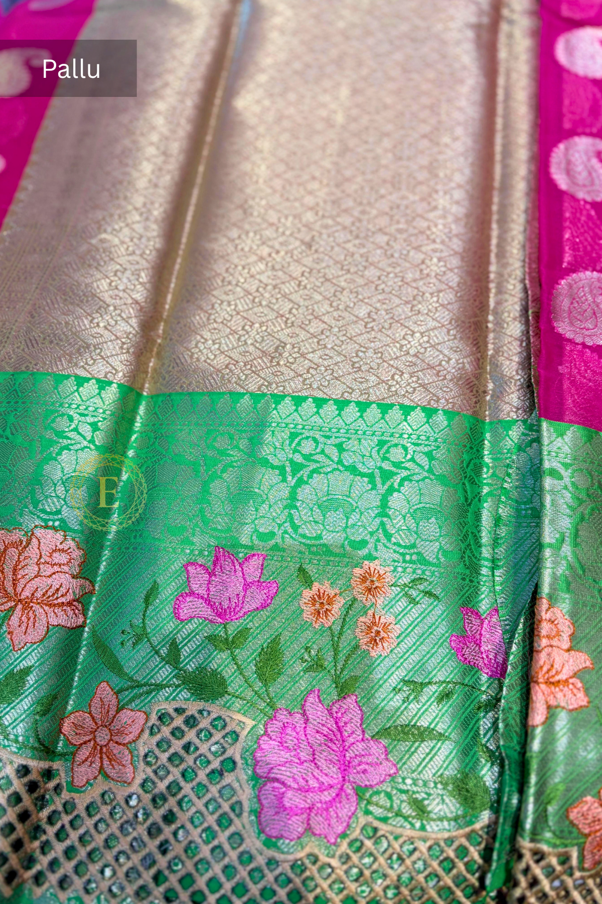 Rani pink semi Banarasi georgette saree with golden paisley buttas and a green Kanchi-style border featuring gold zari and floral embroidery by Ekira.